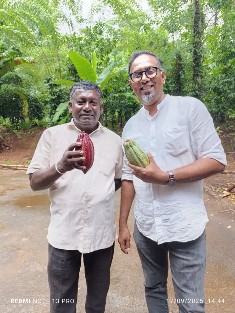 Theolon team members with local cocoa farmers holding fresh cocoa pods